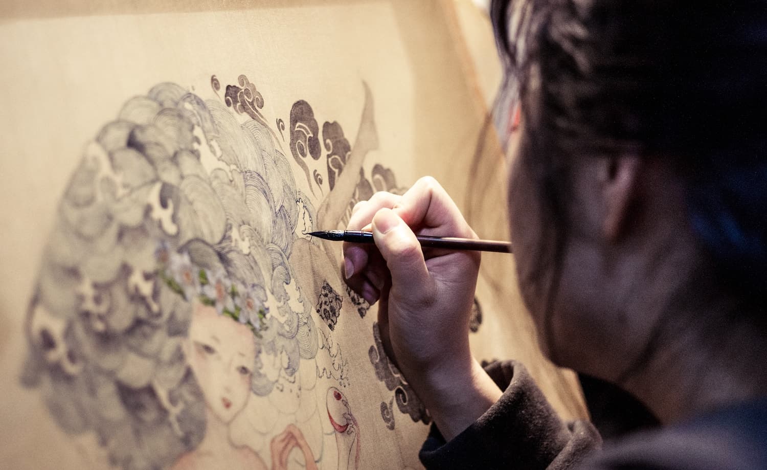 Wenzi Studio artist creating handcrafted designer silk scarves in Toronto workspace